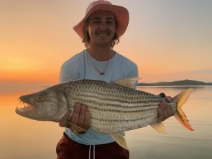 fishing guide with tigerfish caught in Zambia on the zabezi river on fly fishing gear